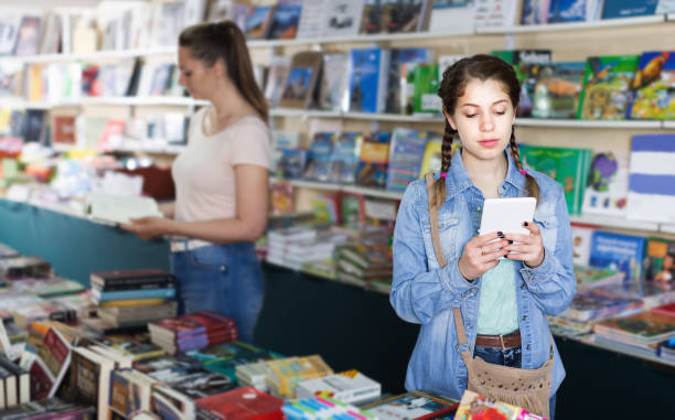 istock Girl chatting on screen tablet at shop 1207484016