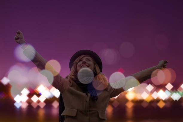 Woman enjoying starry night with arms wide open.