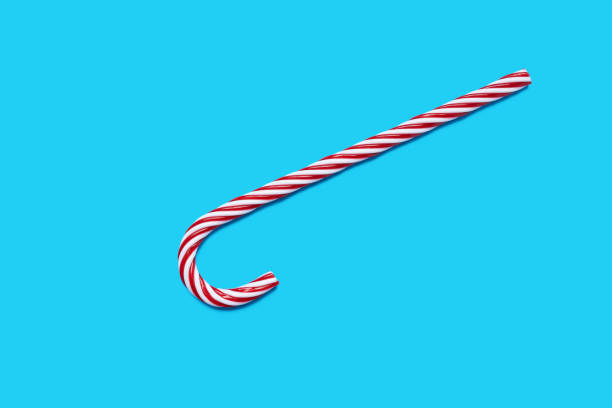 istock Cane Christmas decoration on vibrant blue background. Copy space card congratulation 1207485664