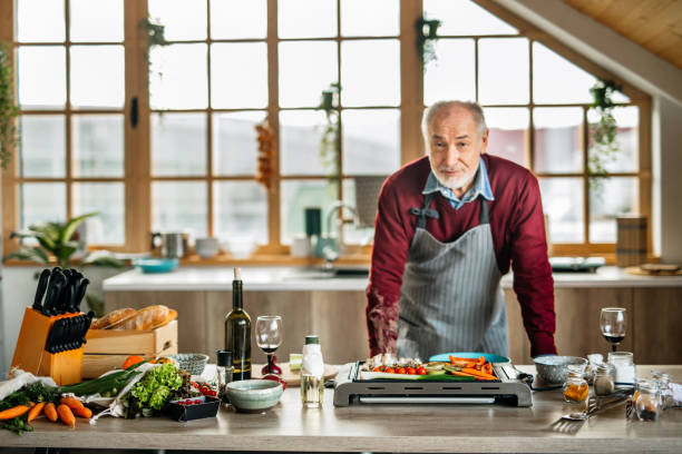 istock Cheerful Senior Man Enjoying Cooking at Home 1207486845