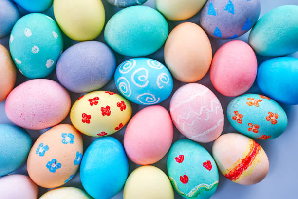 istock Colorful Easter eggs dyed by colored water with beautiful pattern on a pale blue background, design concept of holiday activity. 1207488370