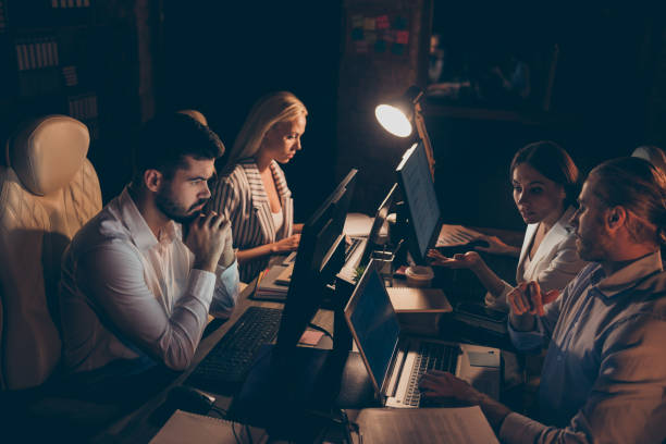 istock Profile side view of nice attractive professional skilled experienced smart clever coworkers sharks experts it geek solving tech problem at night preparing report at work place station 1207488498