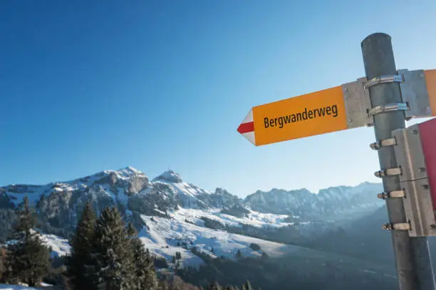 Bergwanderweg is a german word and means hiking mountain trail. In the background mountain Hoher Kasten in the Alpstein Massiv in Appenzell Switzerland