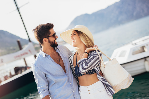 Couple in love, enjoying the summer time by the sea.