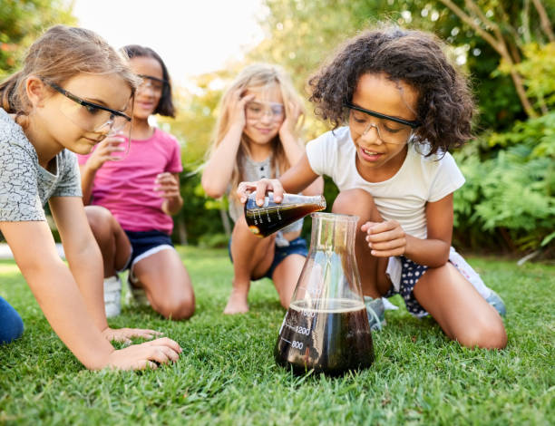 istock Girls experimenting in garden 1207495026