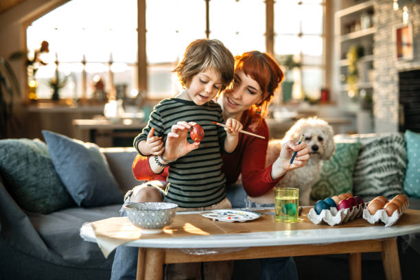 Coloring Eggs For Easter Celebration Mother And Son Enjoying Creative Day In Easter Egg Coloring easter egg coloring stock pictures, royalty-free photos & images