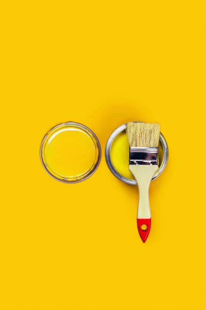 Colored background with paint jar and brush.