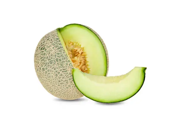Photo of whole and sliced green melon on white background