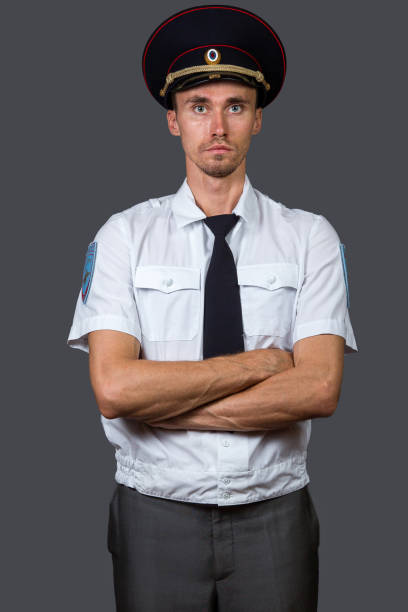 istock Serious skinny Russian policeman looking at camera 1207499401