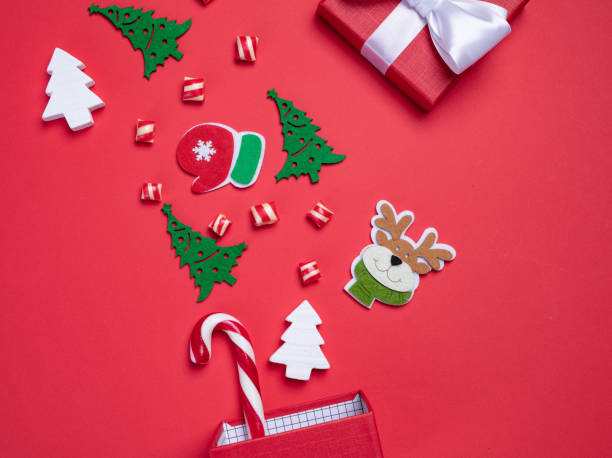 istock Christmas card. Invitation card on a red background. Surprise box with sweets. Interesting proposition for you. 1207500490