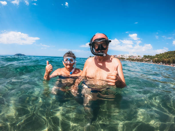 istock Senior couple with snorkeling masks 1207500689