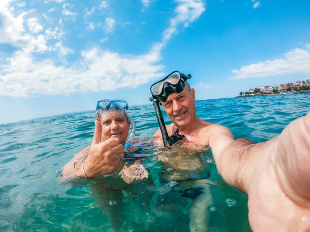istock Senior couple with snorkeling masks 1207500722