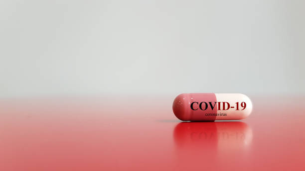 Medication of antiviral capsule(medicine drug) for treatment and prevention of new corona virus infection(COVID-19,novel coronavirus disease 2019 or nCoV 2019 from Wuhan. Pandemic infectious concept medication for treatment corona virus infection(COVID-19,novel coronavirus disease 2019) pill photos stock pictures, royalty-free photos & images