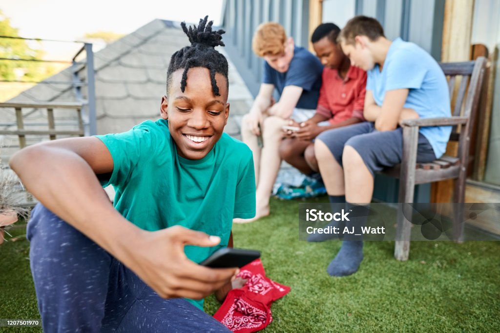 Watching Funny Videos On Smartphone Stock Photo - Download Image Now -  Adolescence, African Ethnicity, Locs - Hairstyle - iStock