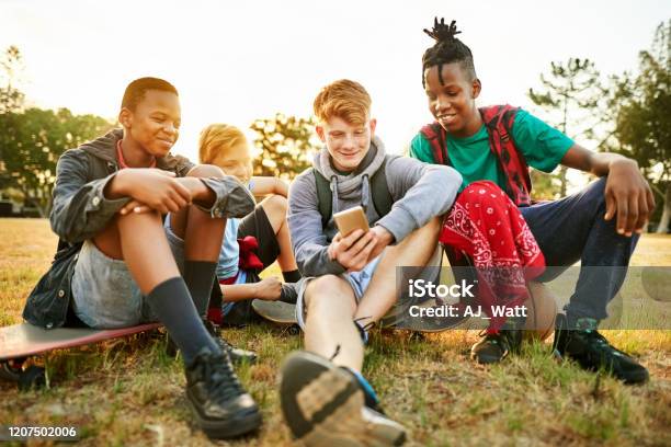 Boys Enjoying Watching Funny Videos Together Stock Photo - Download Image  Now - Addiction, African Ethnicity, Arts Culture and Entertainment - iStock