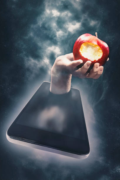 The temptation of knowledge, internet access The temptation of knowledge, Internet access. Hand with an apple in a smartphone apple with bite out of it stock pictures, royalty-free photos & images