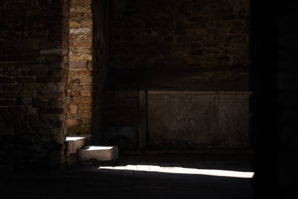 Shadow of a woman wearing headdress reflecting on the floor of an old stone church