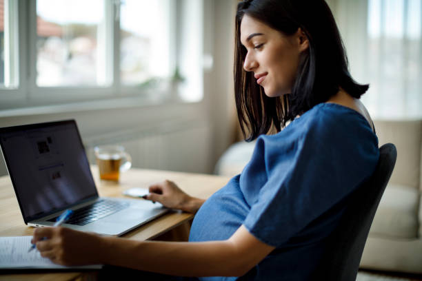 istock Pregnant woman working from home 1207502345