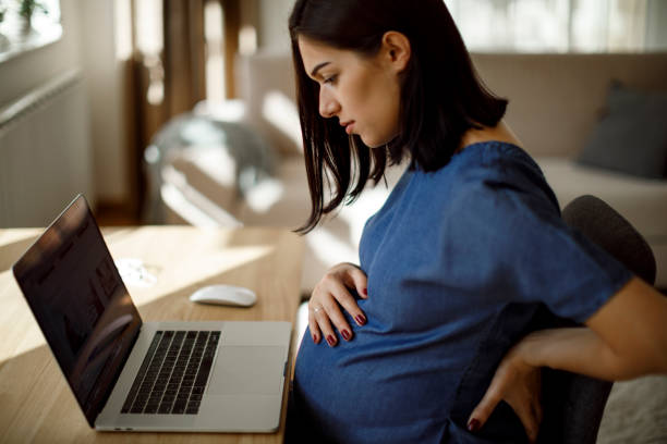 istock Young pregnant woman suffering from backache 1207502421