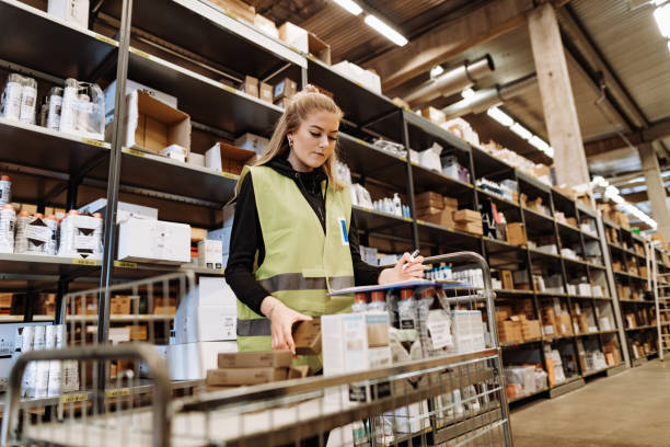 istock Female blue collar employee checking the supply in warehouse 1207502449