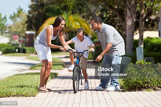 African American Family With Boy Riding Bike Happy Parents Stock Photo - Download Image Now