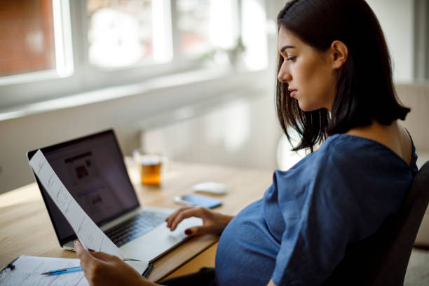 istock Pregnant woman working 1207504807