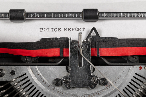 POLICE REPORT typed on a classic typewriter