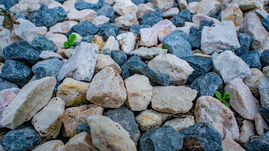 Stone background. blue gravel. Granite texture. The rocky road. Fine pebbles. Construction material. The texture of the stones. Wallpaper with fine gravel.