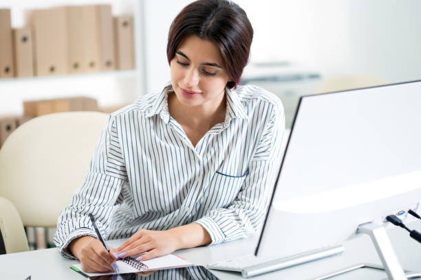 istock Young beautiful business woman with computer 1207508886
