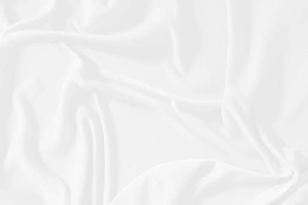 istock White cloth background abstract. Fabric is wrinkled and sofe wave. Material are used in textile assembly. detail texture of pattern design, elegance with free space copy for backdrop or wallpaper. 1207508998