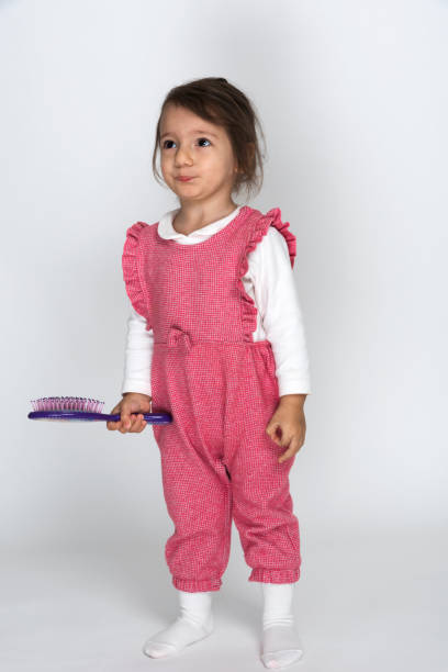 istock Little girl combing her hair. 1207509372