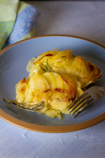 istock Potato gratin on blue plate. Scalloped potatoes or potato bake 1207512206
