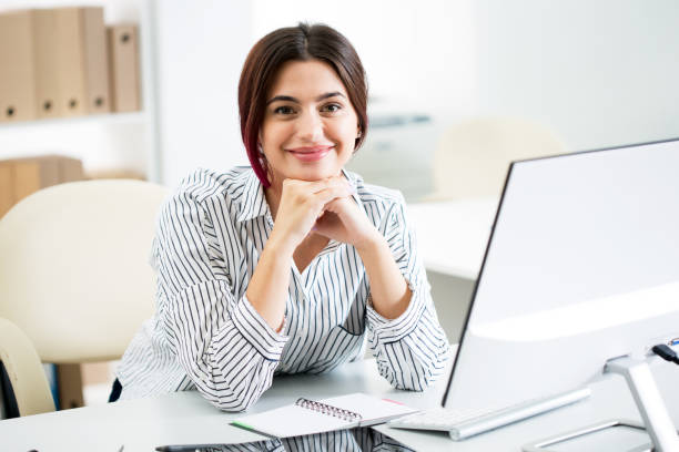 istock Young beautiful business woman with computer 1207512215