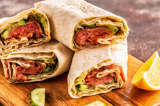 istock Wrapped sandwich with salmon, lettuce, cucumber and cream cheese, selective focus 1207512344