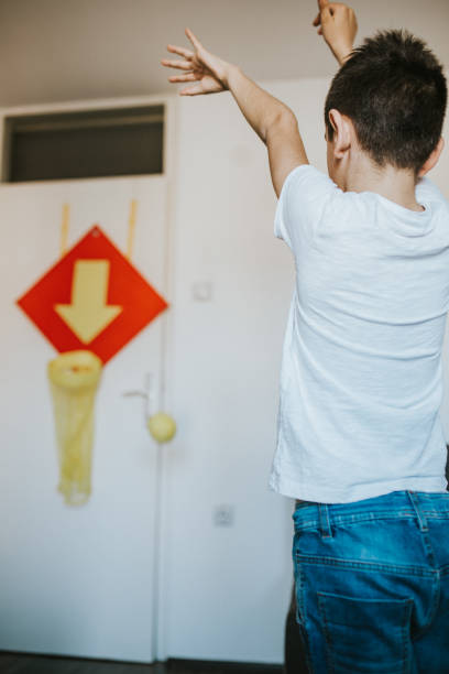 istock Young boy is playing basketball in his room 1207512364