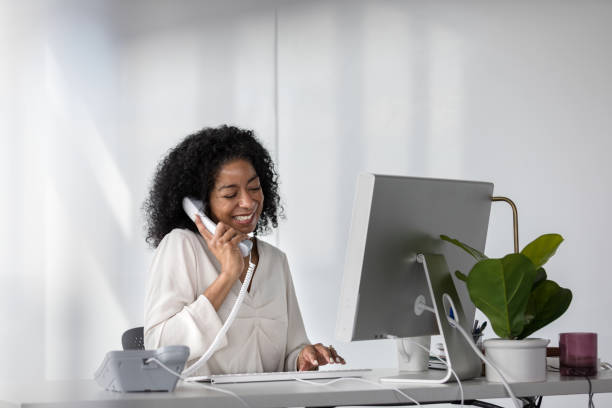 Mature female secretary makes appointments for her boss