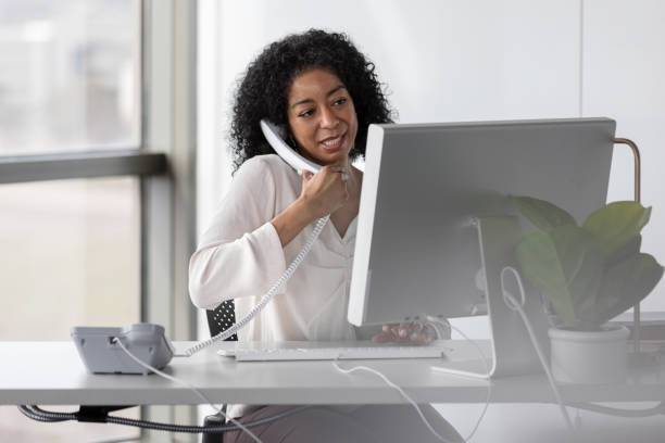 istock Mature female professor speaks with colleagues while typing on keyboard 1207514131