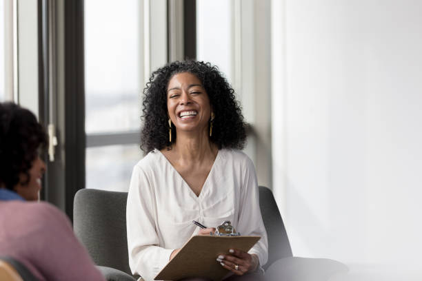 istock A therapist shares a light-hearted moment with patient 1207514168