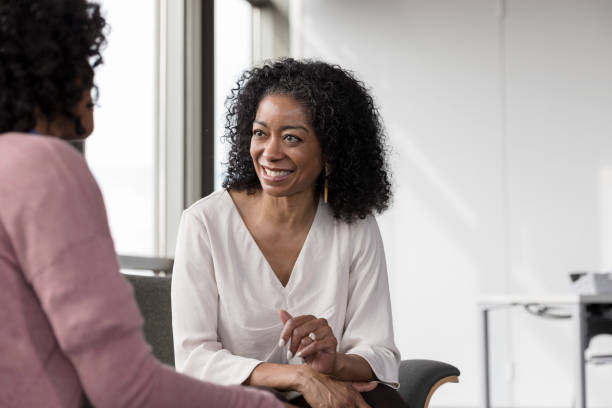 istock Smiling therapist listens to patient during session 1207514172