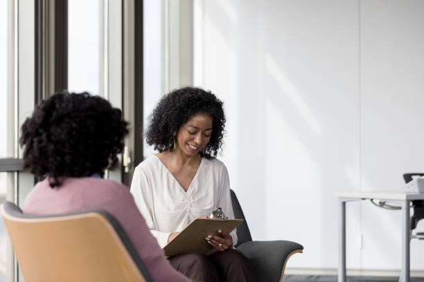 istock Mental health professional takes notes during session 1207514182