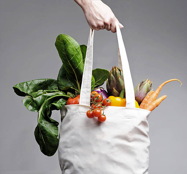 cotton shopping bag overflowing with vegetables - organic bag bildbanksfoton och bilder