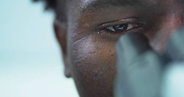 istock African Ethnicity man working in laboratory looks into a microscope 1207517261