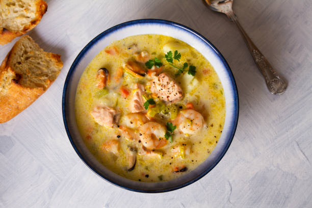 istock Bowl of seafood chowder with salmon on white background 1207517558