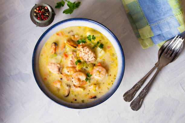 istock Bowl of seafood chowder with salmon on white background 1207517595