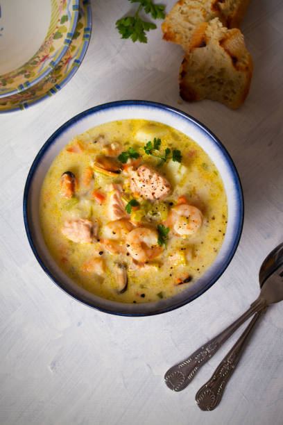 istock Bowl of seafood chowder with salmon on white background 1207517616