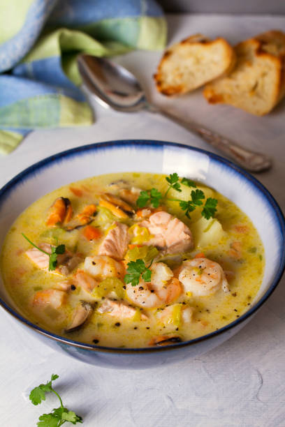 istock Bowl of seafood chowder with salmon on white background 1207517642