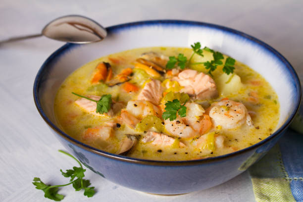 istock Bowl of seafood chowder with salmon on white background 1207517664