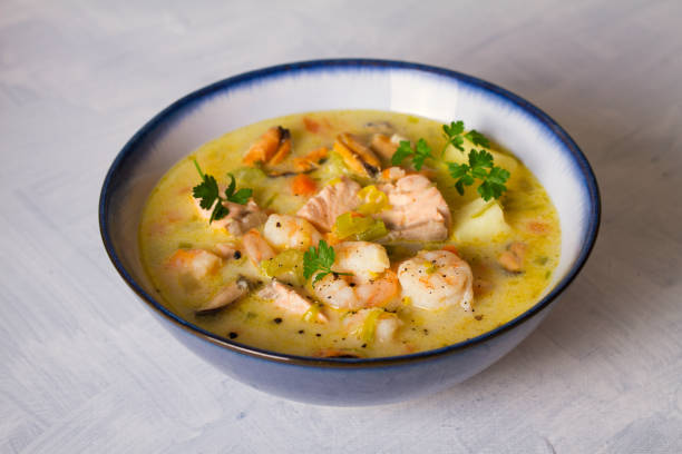 istock Bowl of seafood chowder with salmon on white background 1207517682
