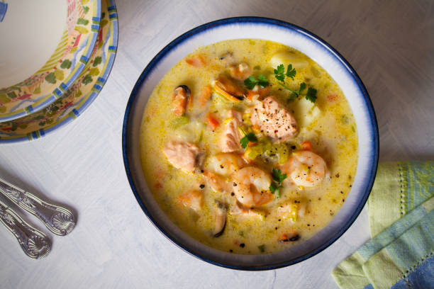 istock Bowl of seafood chowder with salmon on white background 1207517734