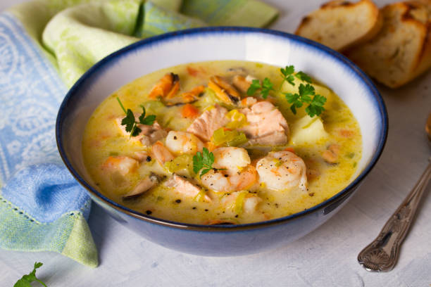 istock Bowl of seafood chowder with salmon on white background 1207517741